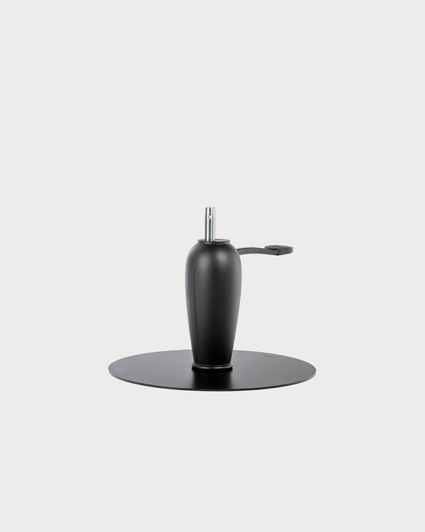 Black barber chair hydraulic pump with cylindrical body and base for salon chair height adjustment
