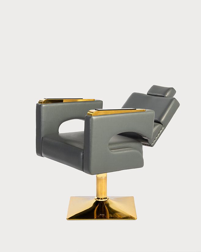 Gray salon chair with gold accents on a white background